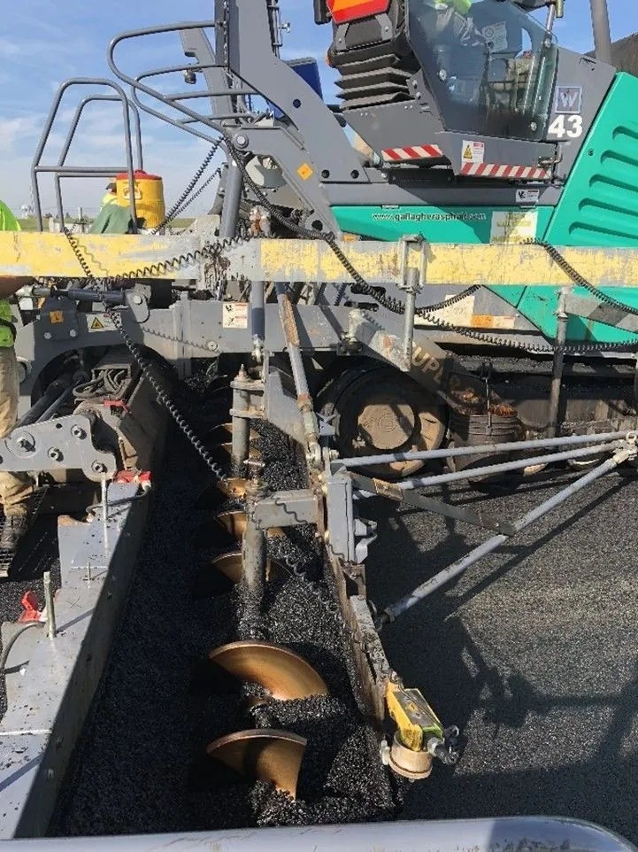 Figure 96. Paving Wide with a Uniform Head of Material