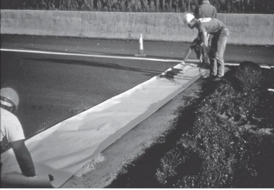 Figure 126. Placement of Kraft Paper Bond Breaker on Transverse Joint